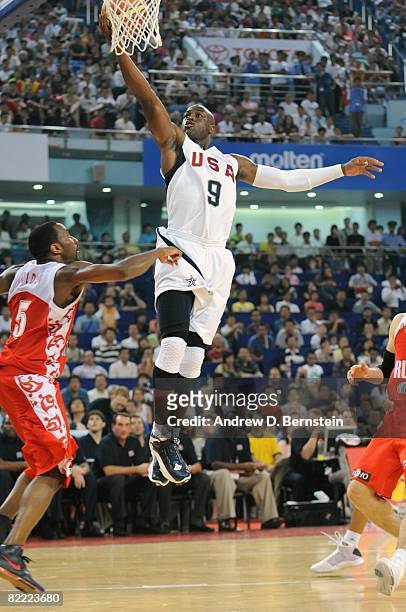 Dwyane Wade of the U.S. Men's Senior National Team shoots a layup against JR Holden of the Russia National Team during a Pre-Olympic Friendly at the...