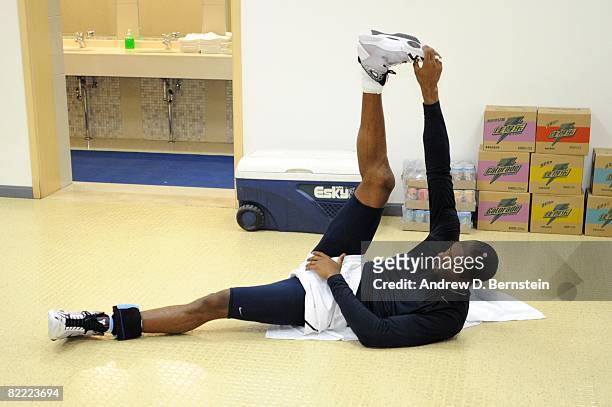 Kobe Bryant of the U.S. Men's Senior National Team stretches prior to a Pre-Olympic Friendly against the Russia National Team at the Qizhong Arena on...