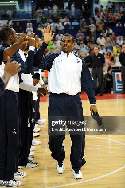 Chris Paul of the U.S. Men's Senior National Team high fives his teammates as he enters the court prior to a Pre-Olympic Friendly against the Russia...