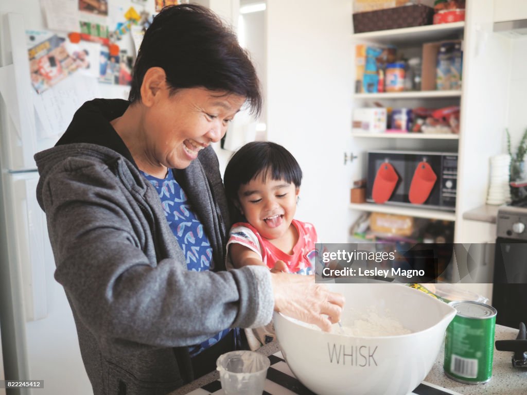 Grandma and grandson baking together