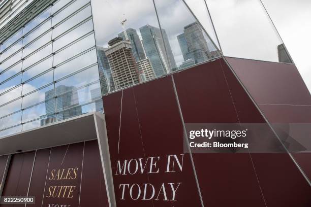 Window in the Dollar Bay residential apartment building reflects the construction of residential flats at The Grid Building, being built by the...