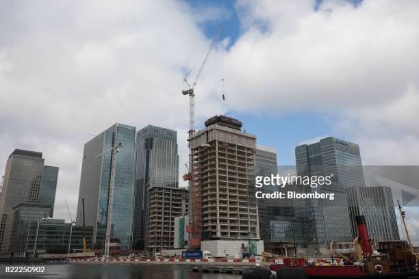 Construction work continues on residential flats at The Grid Building, being built by the Canary Wharf Group Plc, in front of the Canary Wharf...