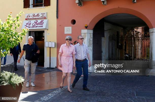 Britain Prime Minister Theresa May walks with her husband Philip in Desenzano del Garda, by the Garda lake, as they holiday in northern Italy, on...