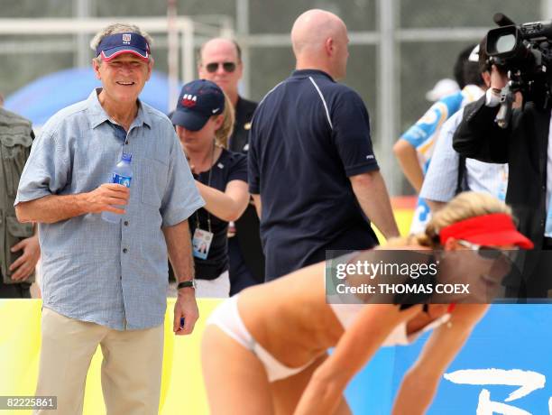 President George W. Bush looks at world and olympic US champion beach volleyball player Kerri Walsh during a visit to the US team at Beijing's...