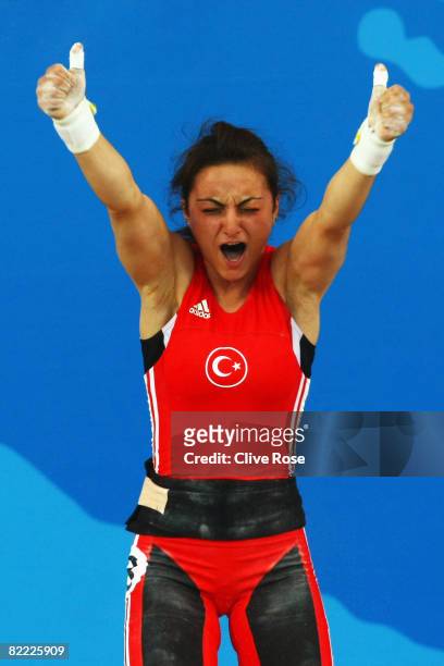 Sibel Ozkan of Turkey celebrates a lift in the Women's 48kg Group A Weightlifting event held at the Beijing University of Aeronautics and...