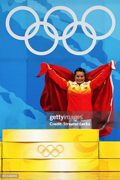 Chen Xiexia of China prepares to receive her gold medal on the podium during the medal ceremony for the Women's 48kg Group A Weightliftin event held...