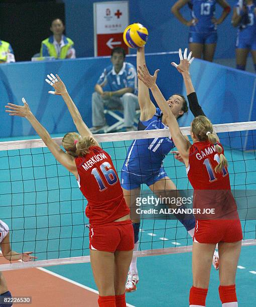 Italy's Serena Ortolani slams the ball onto Russia's Yulia Merkulova and Ekaterina Gamova during the Women's Volleyball opening match Italy vs.Russia...