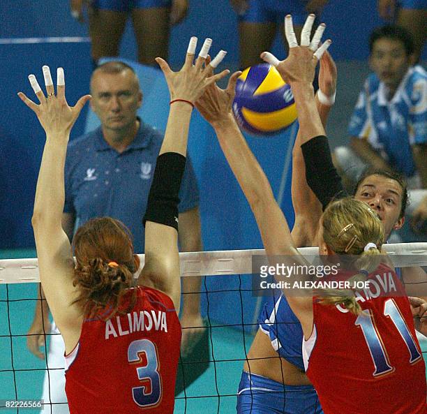 Italy's Serena Ortolani slams the ball onto Russia's Natalia Alimova and Ekaterina Gamova during the Women?s Volleyball opening match Italy vs....