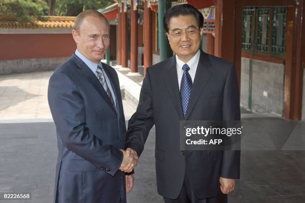 Russian Prime Minister Vladimir Putin meets with Chinese President Hu Jintao at the Zhongnanhai leaders compound in Beijing on August 9, 2008....