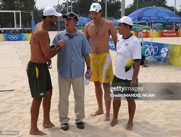 President George W. Bush chats with members of Brazil's men's beach volleyball team during his visit to its Olympic venue in Beijing on August 9,...