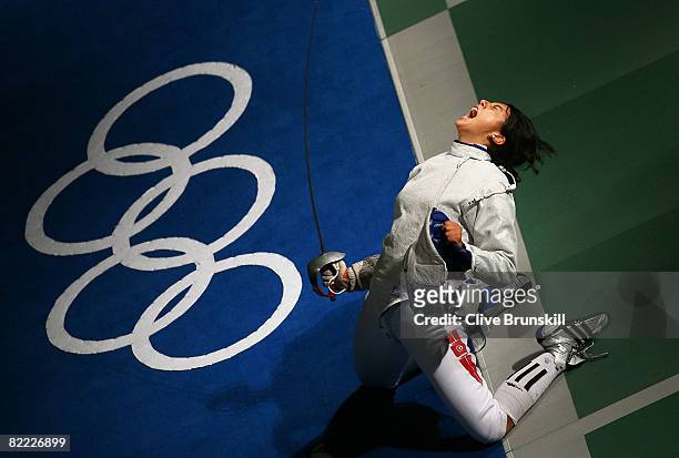 Azza Besbes of Tunisia celebrates winning in the Saber Round of 16 in the fencing event held at the Fencing Hall of National Convention Center during...