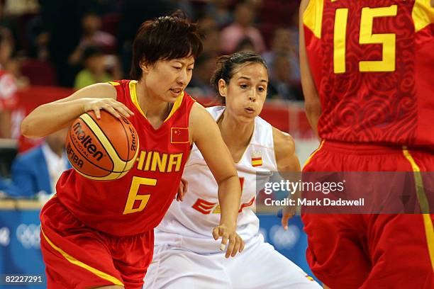 Hanlan Zhang of China drives on Nuria Martinez of Spain during the women's preliminary basketball game at the Beijing Olympic Basketball Gymnasium...