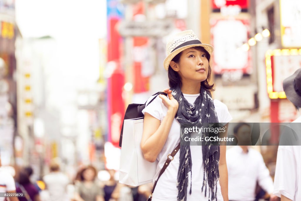 Curious Japanese woman shopping in the streets of Shibuya