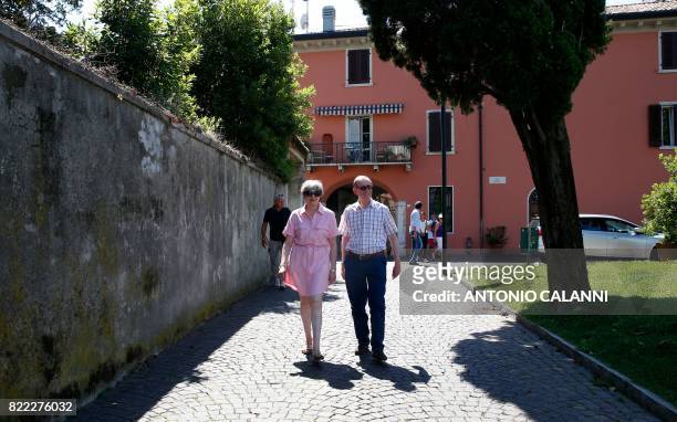Britain Prime Minister Theresa May walks with her husband Philip in Desenzano del Garda, by the Garda lake, as they holiday in northern Italy, on...