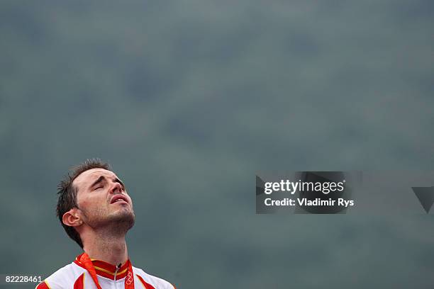 Samuel Sanchez of Spain cries as he listens to his national anthem after winning the gold medal in the Men's Road Cycling event held on the Road...