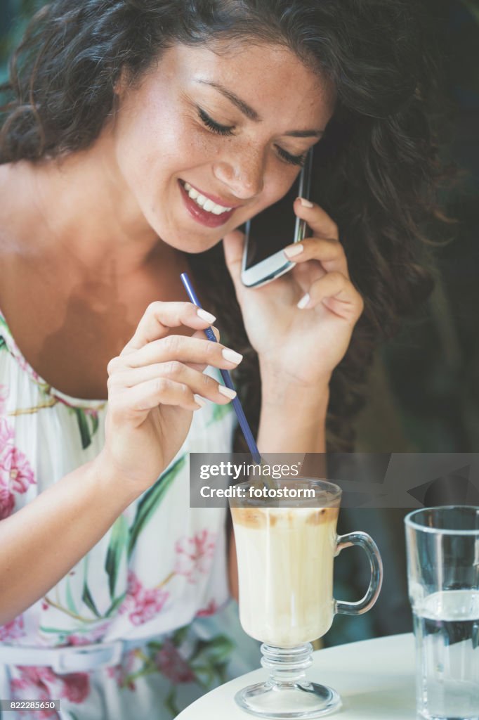 Woman using phone in safe garden