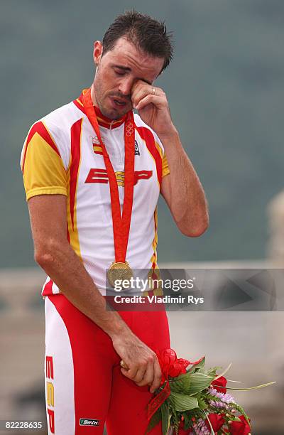 Samuel Sanchez of Spain wipes away tears as he stands on the podium after winning the gold medal in the Men's Road Cycling event held on the Road...