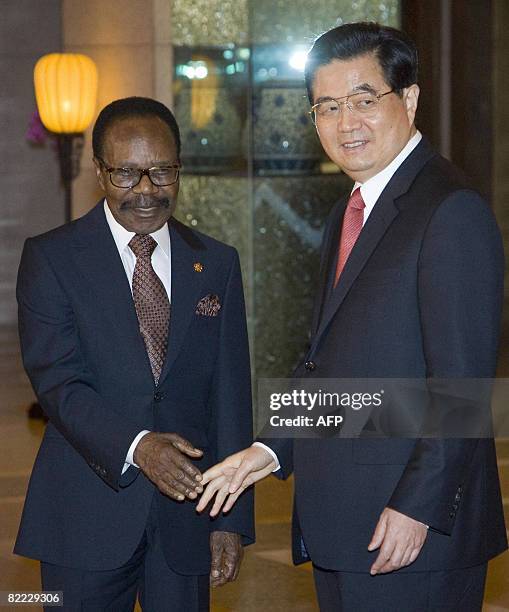 President Omar Bongo of Gabon is greeted by Chinese President Hu Jintao as presidents of eight African countries and the Chairman of the African...