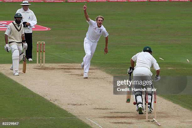 Stuart Broad of England celebrates after bowling Neil McKenzie of South Africa with Hashim Amla of South Africa and umpire Steve Davis looking on...