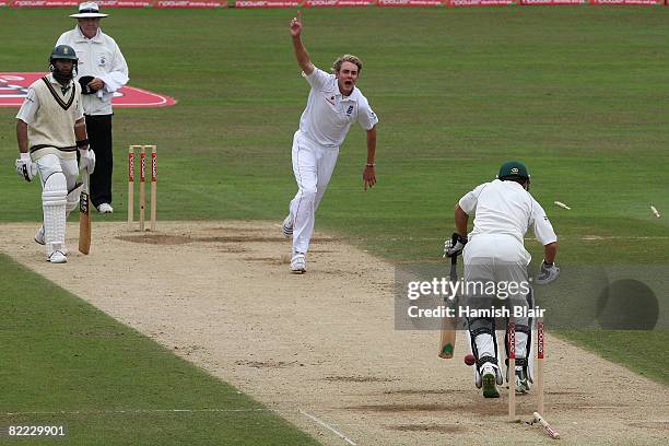 Stuart Broad of England celebrates after bowling Neil McKenzie of South Africa with Hashim Amla of South Africa and umpire Steve Davis looking on...