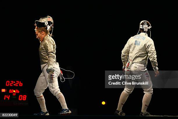 Sada Jacobson of the United States looks on as Mariel Zagunis of the United States he victory for the gold medal in the Sabre fencing event held at...