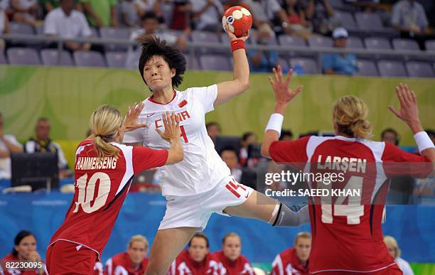 Gro Hammerseng and Tonje Larsen of Norway try to block Liu Xiamiao of China during their 2008 Olympics Games women's Handball match on August 9 in...
