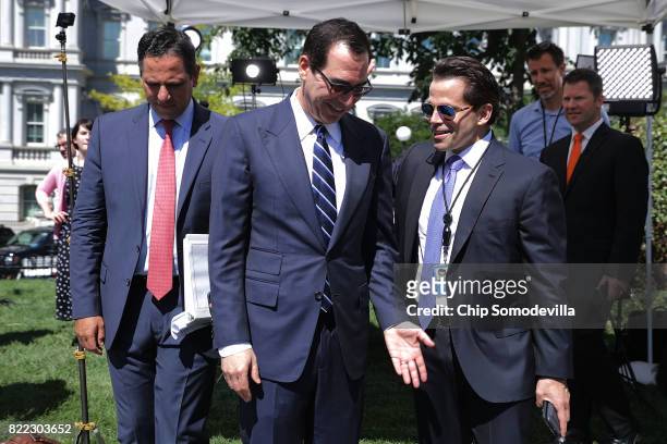 Treasury Secretary Steven Mnuchin talks with incoming White House Communications Diretor Anthony Scaramucci as they are accompanied by Treasury...