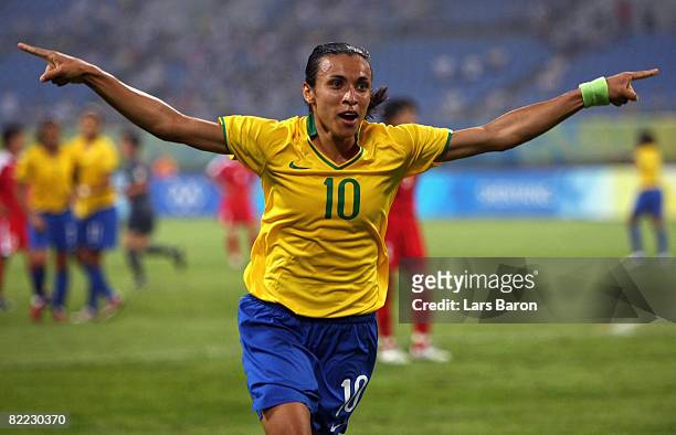 Marta of Brazil celebrates after scoring the second goal during the Women's First Round Group F match between Brazil and North Korea in Shenyang...