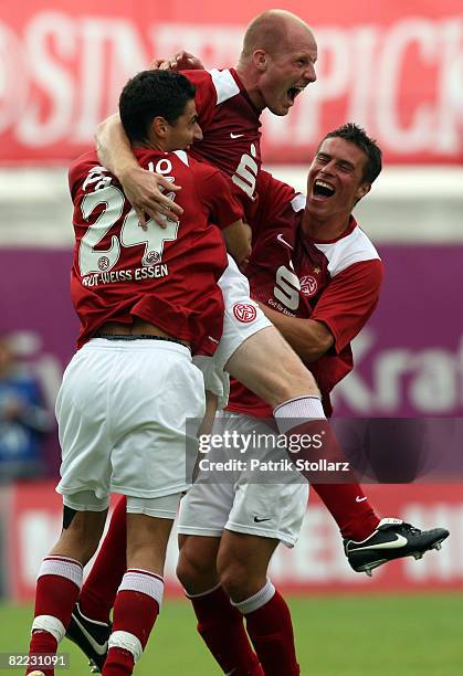 Silvio Pagano , Stefan Lorenz and Jozef Kotula of Essen celebrate after the 1-1 during the DFB Cup first leg match between Rot-Weiss Essen and...