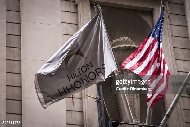 American and Hilton Worldwide Holdings Inc. Flags fly outside the Palmer House Hilton hotel in downtown Chicago, Illinois, U.S., on Monday, July 24,...