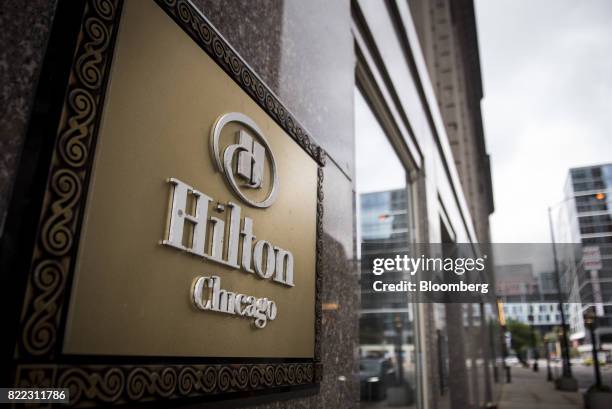 Signage is displayed on the exterior of the Hilton Chicago hotel in downtown Chicago, Illinois, U.S., on Monday, July 24, 2017. Hilton Worldwide...