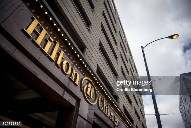 Signage is displayed on the exterior of the Hilton Chicago hotel in downtown Chicago, Illinois, U.S., on Monday, July 24, 2017. Hilton Worldwide...