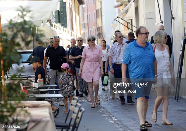 British Prime Minister Theresa May, left, walks with her husband Philip close to Lake Garda on July 25, 2017 in Desenzano del Garda, Italy. May is...