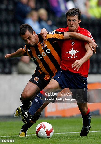 Richard Garcia of Hull is tackled by Oier Sanjurjo of Osasuna during the pre season friendly match between Hull City and Atletico Osasuna at the...