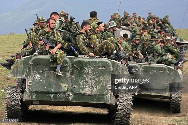 Russian troops sit on armoured personnel carriers in the South Ossetian town of Dzhava on August 9, 2008. Russian Prime Minister Vladimir Putin said...