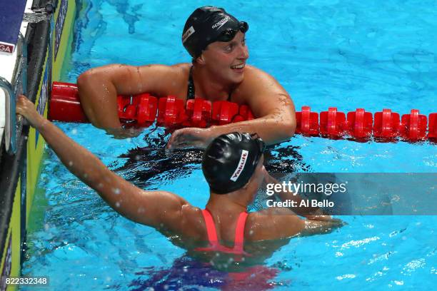 Katie Ledecky of the United States celebrates after winning the gold medal with silver medalist Mireia Belmonte of Spain during the Women's 1500m...