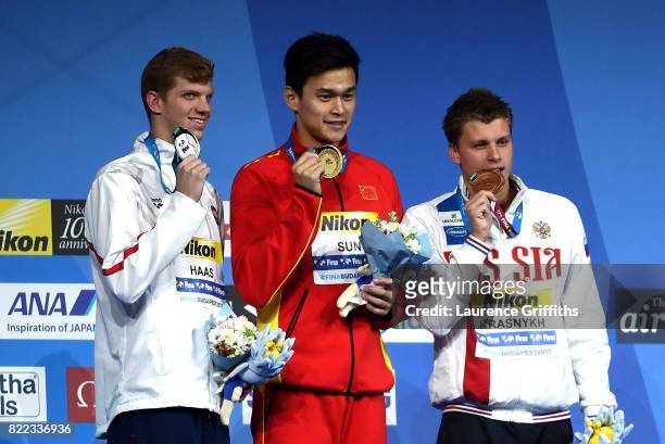 Silver medalist Aleksandr Krasnykh of Russia, gold medalist Yang Sun of China and bronze medalist Townley Haas of the United States pose with the...