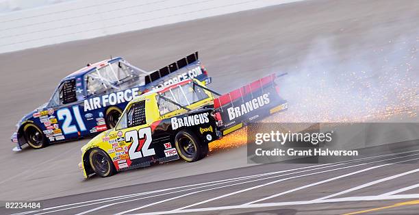 Michael Arnette, driver of the Pilot Travel Centers/Brangos Toyota trails sparks in turn one during the NASCAR Carftsman Truck Series Toyota Tundra...