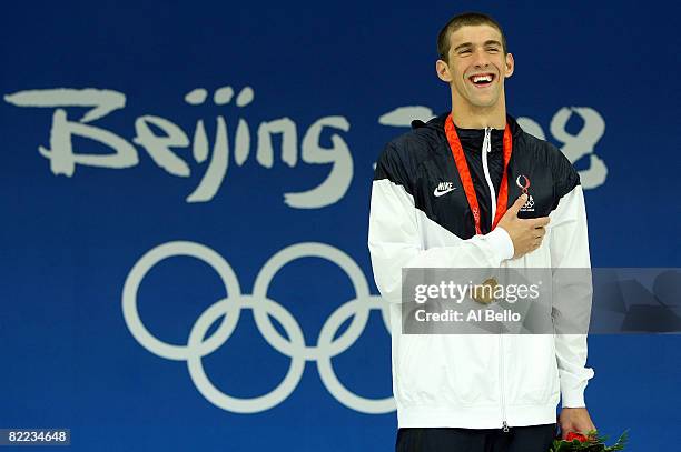 Michael Phelps of the United States receives the gold medal during the medal ceremony for the Men's 400m Individual Medley event held at the National...