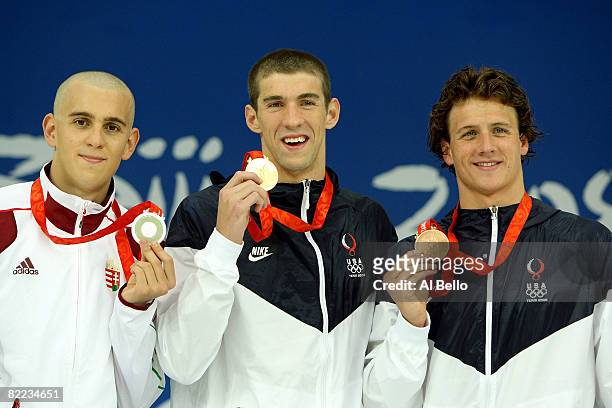 Silver medalist Laszlo Cseh of Hungary, gold medalist Michael Phelps of the United States and bronze medalist Ryan Lochte of the United States stand...