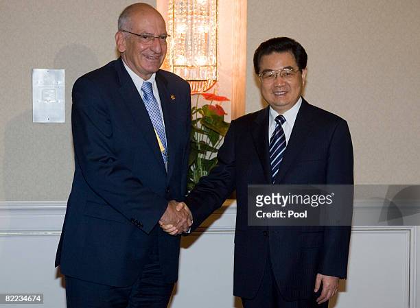 Swiss President Pascal Couchepin meets with Chinese President Hu Jintao as they attend a breakfast meeting with twelve national leaders August 10,...