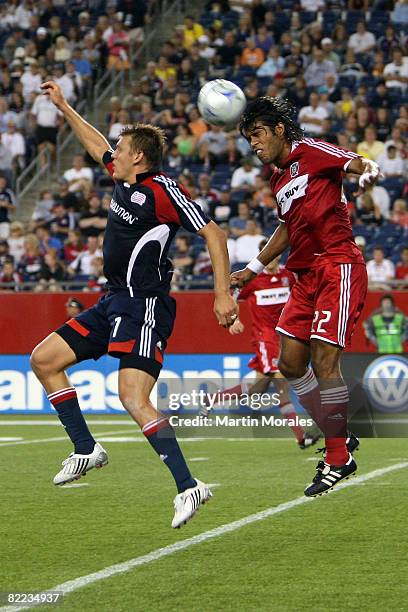 Adam Cristman of the New England Revolution and Wilman Conde of the Chicago Fire go up for the header during the game at Gillette Stadium on August...