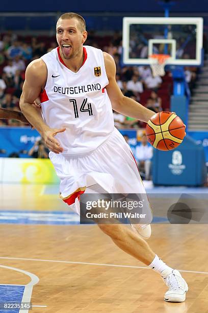 Dirk Nowitzki of Germany moves the ball while taking on Angola during the day 2 preliminary game at the Beijing 2008 Olympic Games in the Beijing...