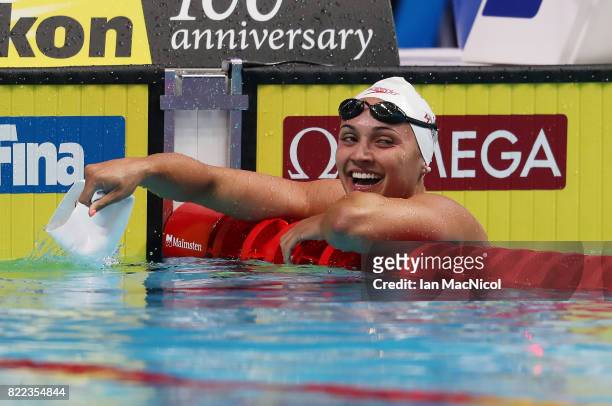 Kylie Jacqueline Masse of Canada reacts as she breaks the world record during the Woens 100m Backstroke semi final during day twelve of the FINA...
