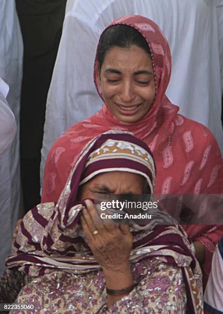 Pakistani relatives of the blast victims mourn during funeral ceremony after a suicide bomb attack in Lahore, Pakistan on July 25, 2017. An explosion...