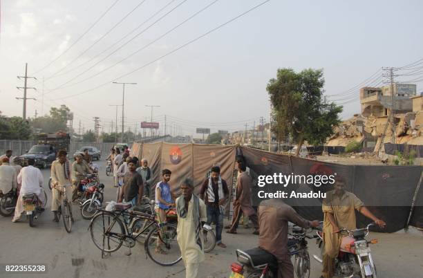 Pakistani people gather around to look at site of bomb blast a day after a suicide bomb attack in Lahore, Pakistan on July 25, 2017. An explosion...
