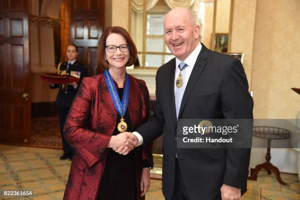 In the handout provided by Government House, Sydney, former Australian Prime Minister Julia Gillard shakes hands with Governor-General of Australia...
