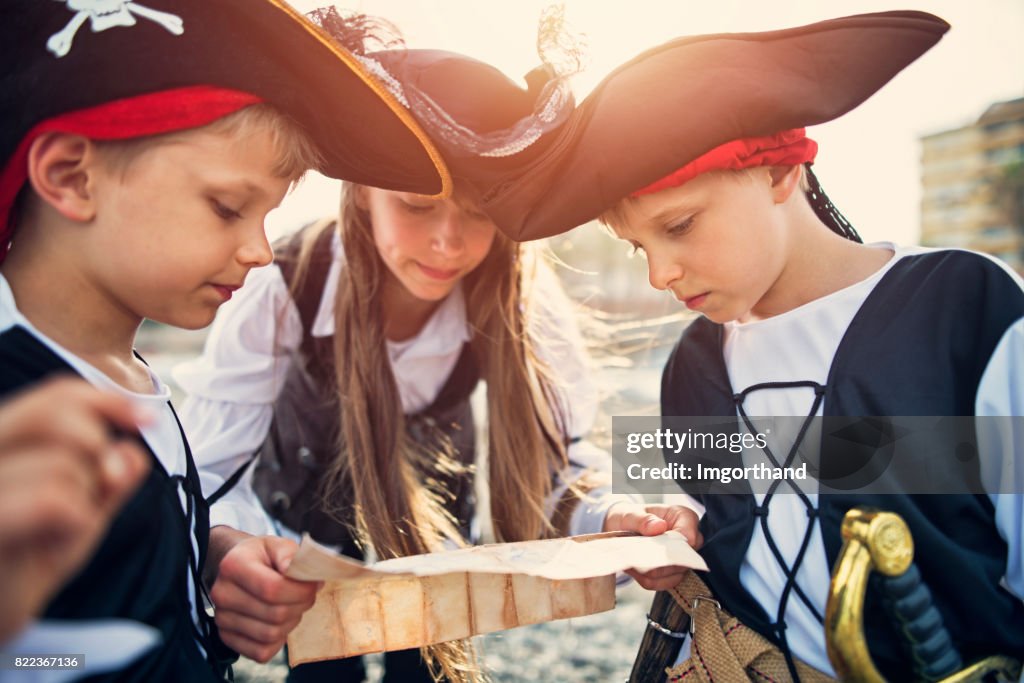 Kids playing pirates on a beach