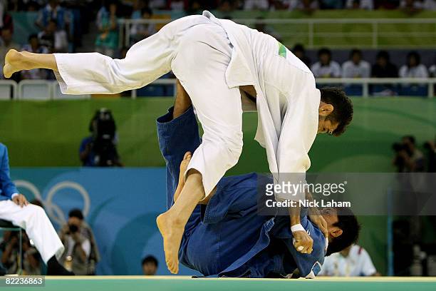 Masato Uchishiba of Japan throws Arash Miresmaeili of Iran in their -66 kg men's preliminary judo event held during day 2 of the Beijing 2008 Olympic...