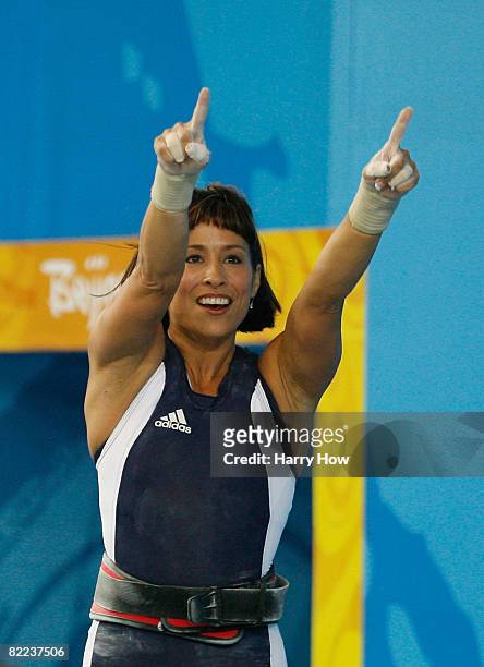 Melanie Roach of the United States acknowledges a section of the crowd as she celebrates after a sucessful lift in the women's 53kg group A...